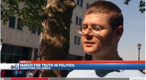 Screenshot of TV broadcast showing interview of Gleb Tsipursky during March For Truth In Politics in Columbus, Ohio